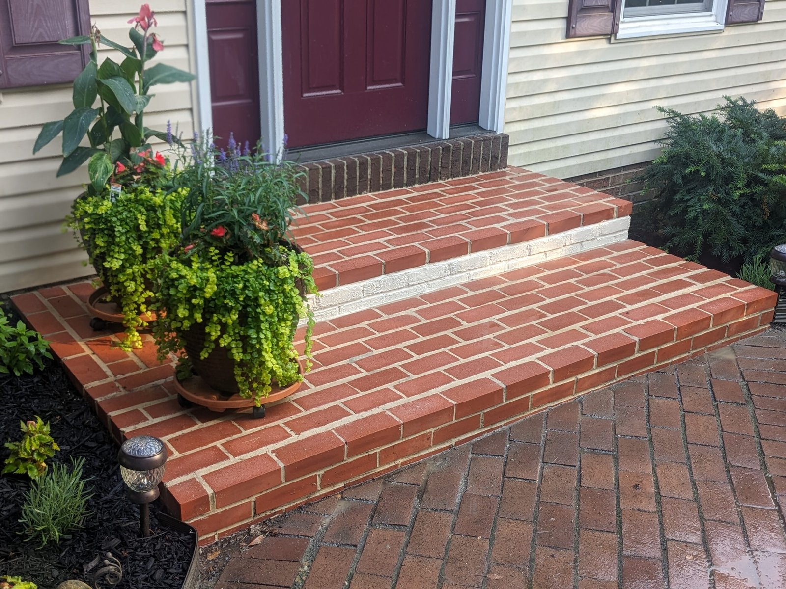 New brick front steps installation with concrete treads and paver driveway in York PA by LBE Masonry