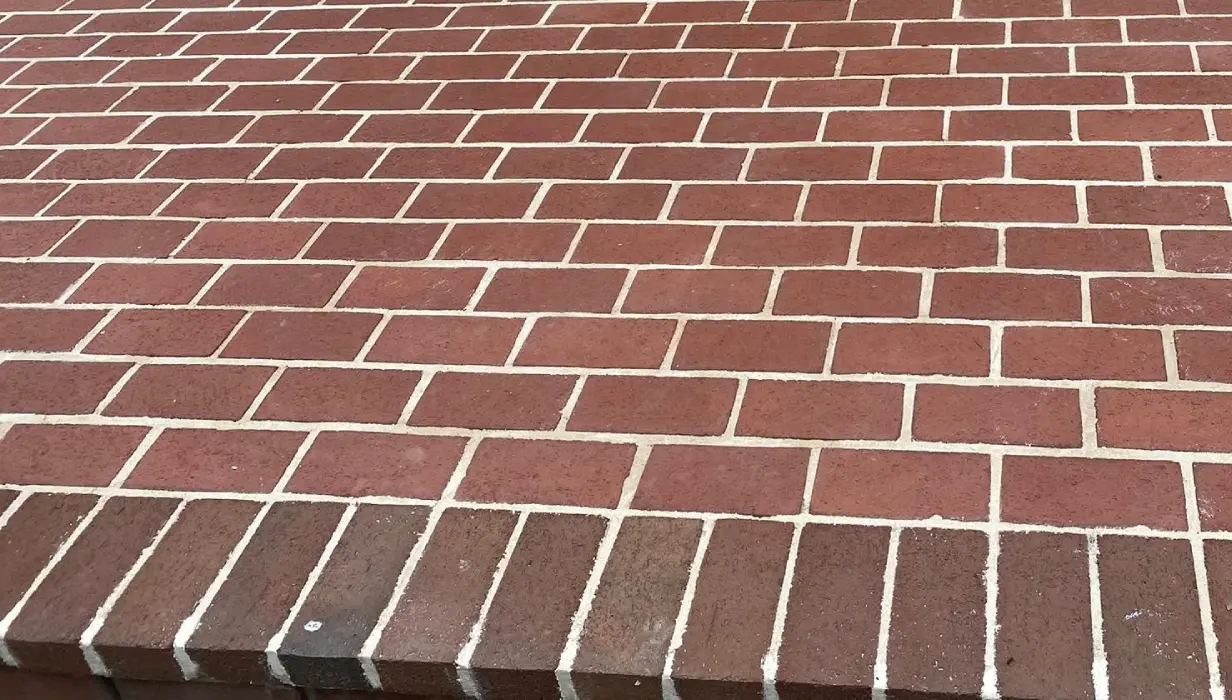 Brick wall showing water damage and spalling before sealing