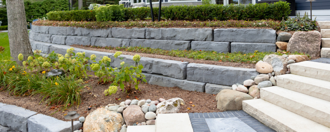 Leaning retaining wall with visible damage and mortar failure, York County PA masonry repair
