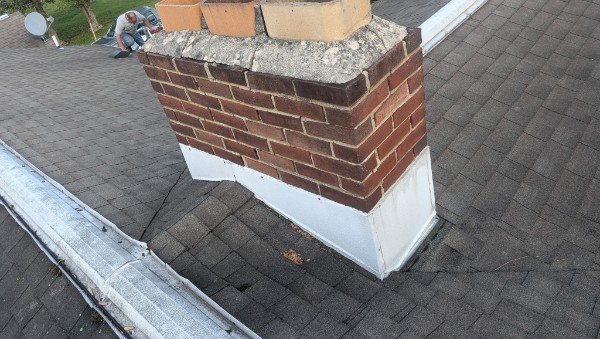 Chimney torn down to flashing exposing three flue liners during teardown and rebuild in York PA by LBE Masonry