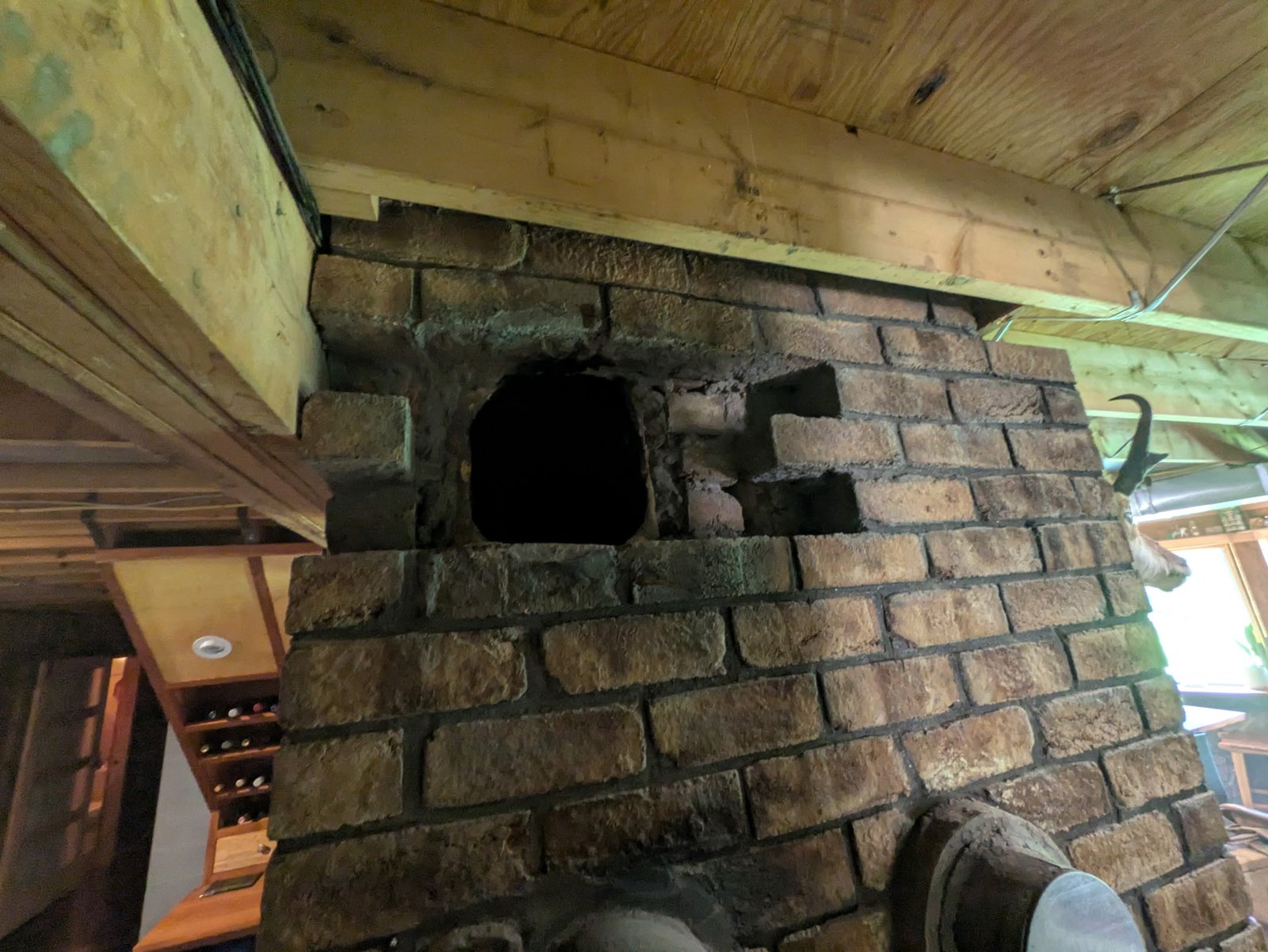 Before: deteriorated terracotta vent opening with damaged and mismatched brick on interior masonry wall before LBE Masonry restoration