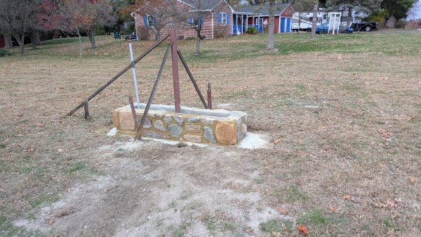 Stone veneer church sign base wide view showing fieldstone veneer on block with A-frame metal sign structure in Glen Rock PA by LBE Masonry