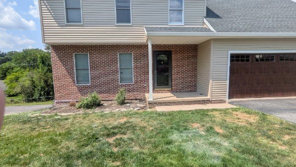 Wide view of completed thin brick veneer front wall on residential home in New Freedom PA by LBE Masonry