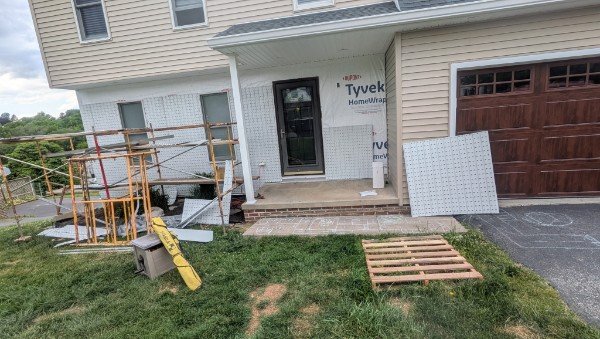 Thin brick veneer panels being installed on front facade with scaffolding in New Freedom PA by LBE Masonry